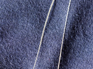 A comparison of the width of the straw used in the finest hat ever woven with dental floss.  Dental floss, on the left, is the thick one.