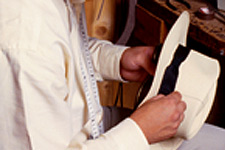 Sewing the ribbon on a Panama hat