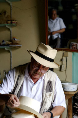 Nice hats. Don Rosendo looks at me as I look at hats. The hat I’m inspecting won a trip to Hawaii. Photo © 2005 Roff Smith