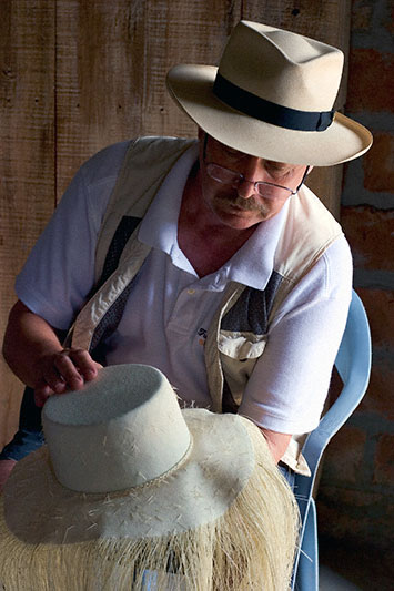 B Brent Black judging a panama hat in process.